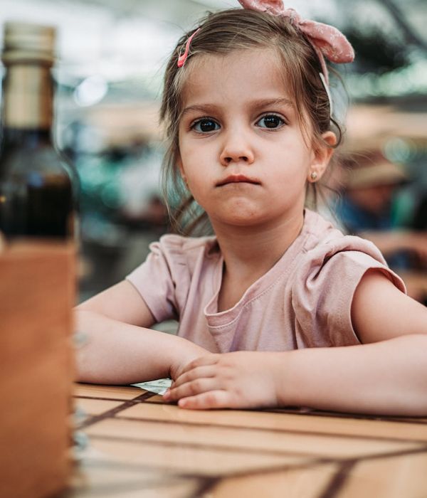 Child sitting cross-legged with eyes closed, looking calm and focused.